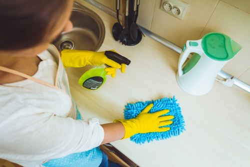 Technician using protective gear during professional carpet cleaning