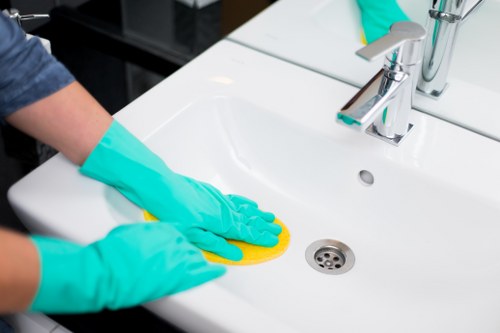 Cleaner refreshing a sofa during upholstery cleaning in Wealdstone